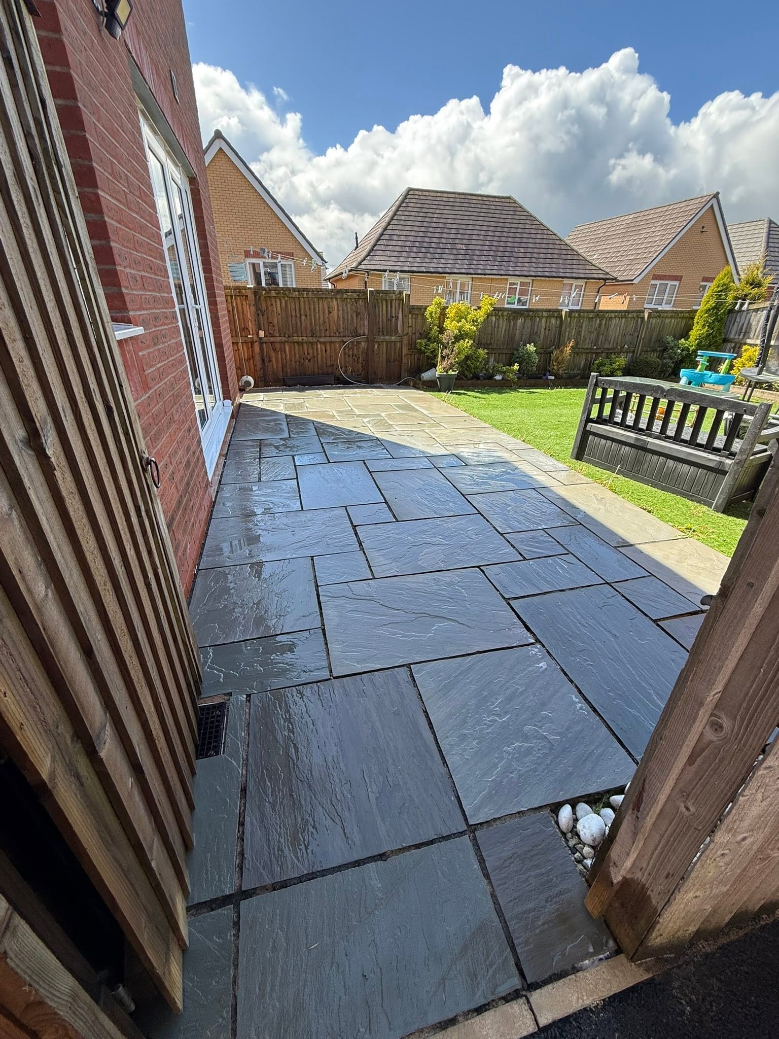 Dark slate patio cleaned and sealed in the sun